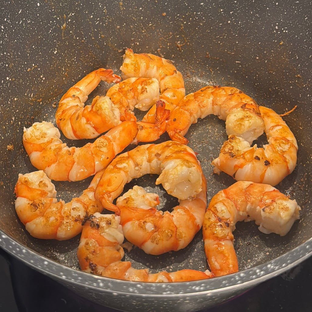 Tiger Prawns  cooking in a pan on a stove